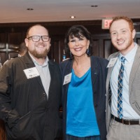 President Mantella smiles with two men in front of bar at Leading the Way to D.C.